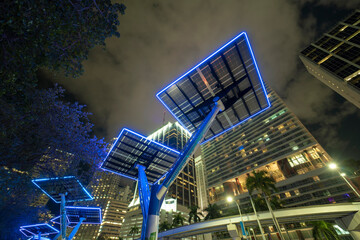 Downtown district of Miami city with photovoltaic panels mounted on metal poles for electricity...