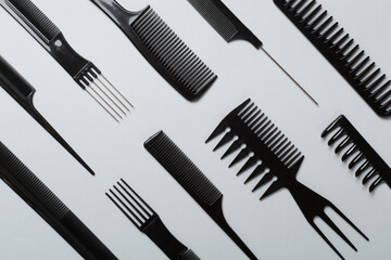 Professional combs and hairdresser tools on color background, top view