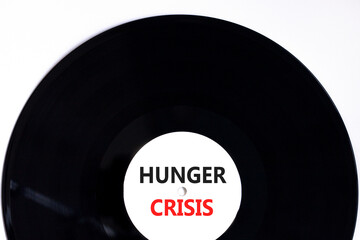 Hunger crisis symbol. Concept words Hunger crisis on beautiful black vinyl disk on a beautiful white table white background. Business, support and Hunger crisis concept. Copy space.