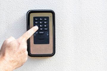 Hands typing on home intercom