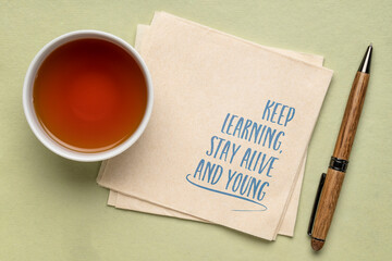 keep learning, stay alive and young - inspirational note on a napkin, aging, healthy lifestyle and personal development concept