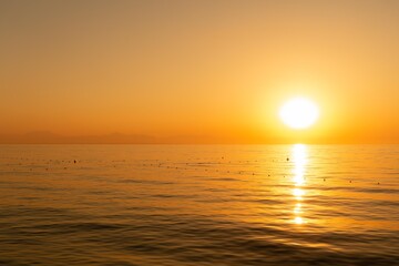 Dawn over Antalya, View from the coast of Beldibi, Türkiye. Summer morning on the sea coast in orange shades, wallpaper.