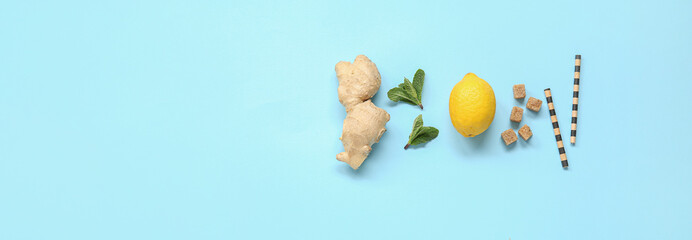 Ingredients for lemonade on light blue background with space for text