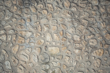 Masonry wall of natural brown stones with irregular pattern texture background. Typical masonry wall in Spain