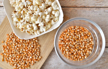 Popcorn home cooking and corn seeds on wooden background