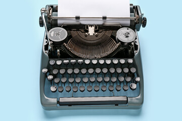 Vintage typewriter with blank paper sheet on blue background