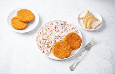 Fresh prepared fish cutlets with rice