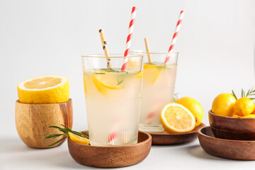 Glasses with fresh lemonade on grey background