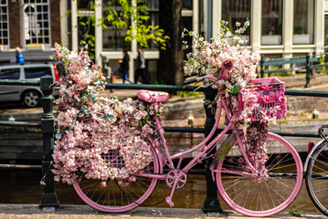 Fototapeta na wymiar Creatively decorated bicycles parked over the Amsterdam canals.