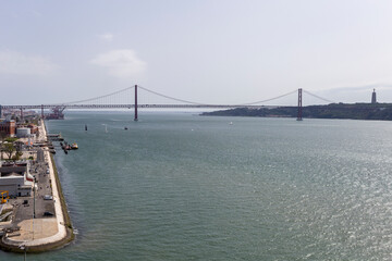 View of the 25th of April Bridge from the Monument of the Discoveries on a summer day in Lisbon