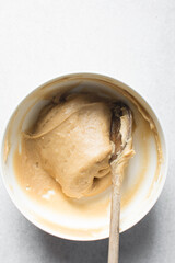 Churros dough in a white bowl, process of making churros, choux pastry dough about to be fried