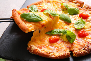 Board of tasty pizza margarita with stretching cheese on table, closeup