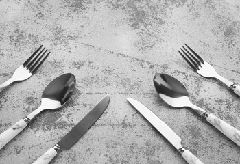 Silver cutlery on grey grunge background