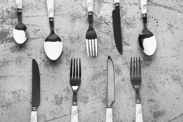 Silver cutlery on grey grunge background