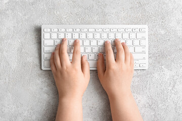 Female hands with modern computer keyboard on light background