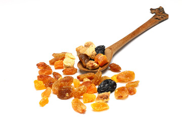 Mix of nuts and dried fruits in wooden spoon isolated on a white background.