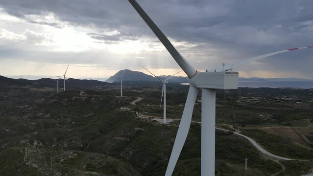Wind turbines stays idle in windless weather, aerial close-up shot