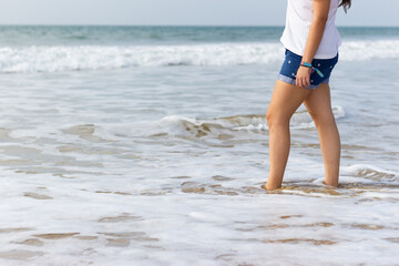 Legs of young girl on the seashore. concept of relaxation. Concept of healthy living.