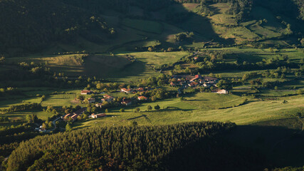 Landscape of the aerial view of the small town of Salmanton in the green and rural countryside environment of the Maroño reservoir, in the Ayala or Aiaraldea valley, Alava, Basque Country.