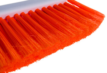 colored household broom brush for home and car with a plastic handle and a scraper for a snow plow