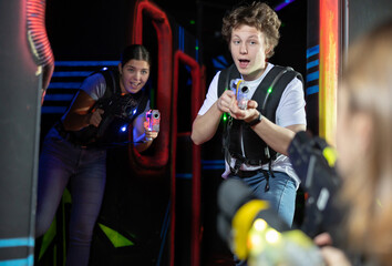 Guy and girl playing lasertag in arena