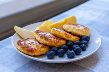 Traditional Ukrainian cheesecakes with apples and blueberry 