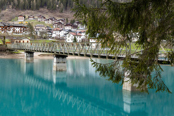 Beautiful view of bridge and reflections on Auronzo Lake turquoise water, in Auronzo di Cadore;...