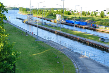 gates, close passage through narrow lock on navigable river Main in Germany, transportation of goods, cargo, ships through shipping channels, lock systems