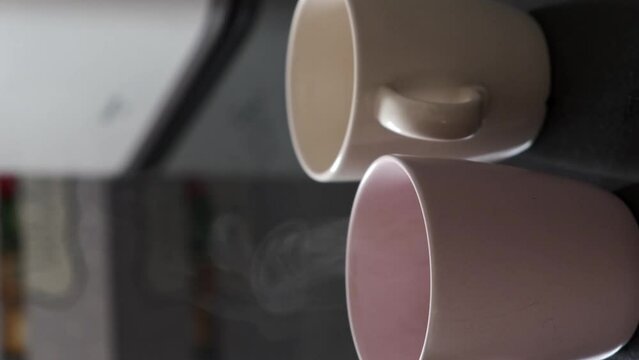 prepare two breakfast cups with milk to enjoy a hot drink
