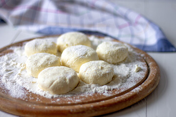 Raw cottage cheese pancakes . Unbaked buns. Ukrainian dish of cottage cheese. 