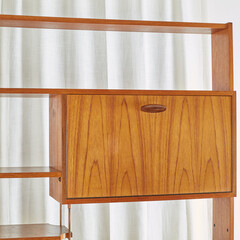 Stylish vintage 1960s room divider. Classic Mid-Century Modern teak sideboard. Refined sculptural furniture. Detail photograph of shelf and cabinet.