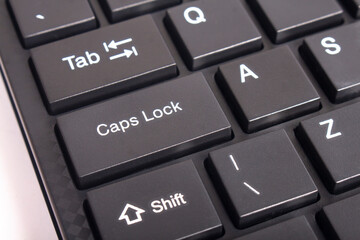 Capslock key on a computer keyboard. Focus on the word capslock it's on the right side.