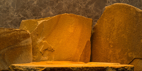 podium stones for product presentation background on orange gold background. brown stones with...