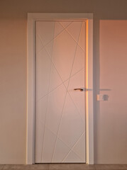 White modern indoor doors close up at home during golden hour