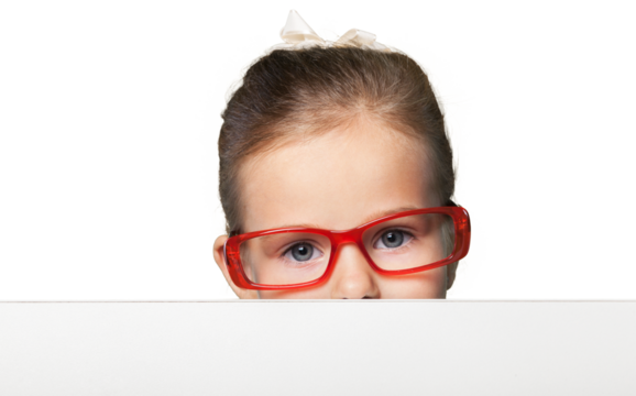 Girl in red-framed eyeglasses looking up from behind the table