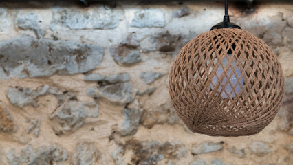 close up view of straw knit jute lampshade. Copy space for vintage wallpaper