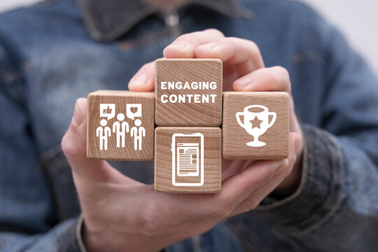 Man holding wooden cubes with icons and inscription: ENGAGING CONTENT. Concept of Engaging Content. Web content marketing success, social media sharing, lead generation.