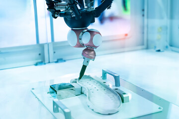 Robot holding glue syringe Injection on shoe in intellegence factory