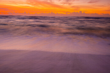 Fototapeta na wymiar Sunrise on The Waves and The Sandy Shore of Lydgate Beach, Lydgate Beach Park, Kauai, Hawaii, USA