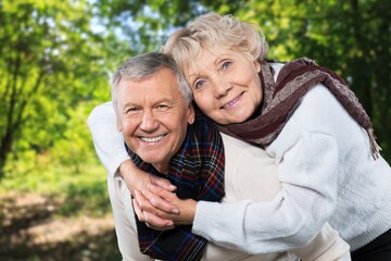 Portrait of old cheerful people walking in forest