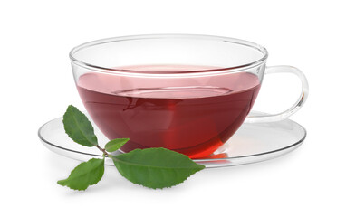 Glass cup of hot aromatic tea and green leaves on white background