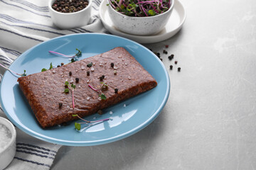 Fresh raw vegan mince with spices on light grey marble table. Space for text