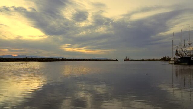 Steveston Harbour Dusk Clouds 4K UHD. A tugboat departs Steveston Harbor at dusk. Richmond, British Columbia. 4K UHD.
