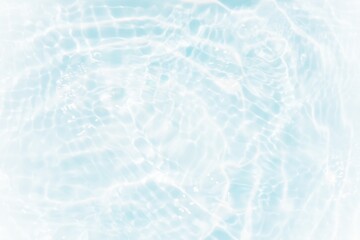Blue water with ripples on the surface. Defocus blurred transparent blue colored clear calm water surface texture with splashes and bubbles. Water waves with shining pattern texture background.