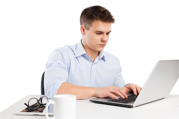 Handsome young businessman working with laptop in office