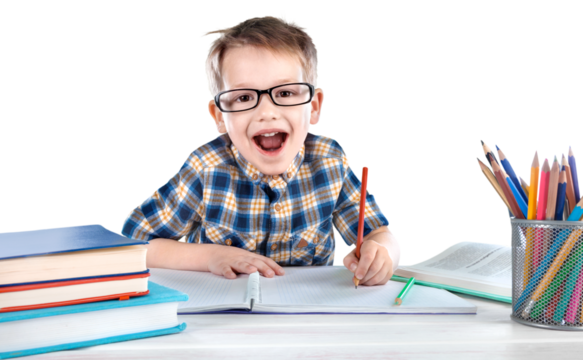 Happy child writing in a notebook in the classroom