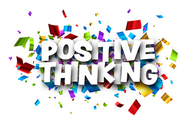 Positive thinking sign over cut out foil ribbon confetti background.