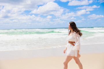 Fototapeta na wymiar 海辺を歩く白いドレスの白人の少女の横顔