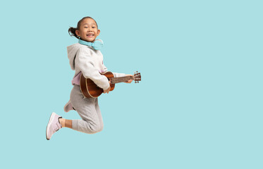 School girl, Happy Asian student school kid jumping for joy with hand holding guitar ukulele, Full...