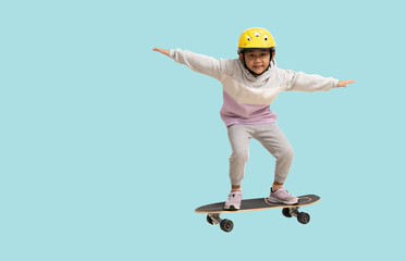 Happy asian smiling little girl playing skateboard wearing a helmet, Full body portrait isolated on...